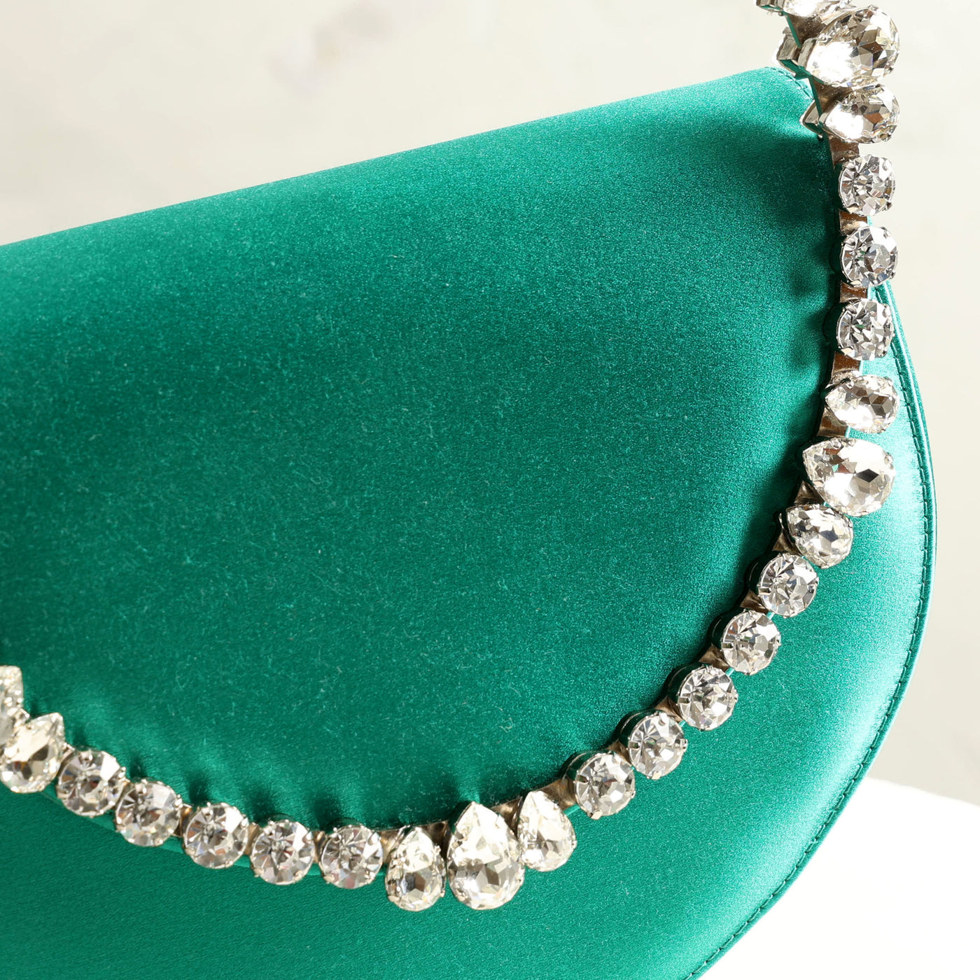 LALINGI Lily Clutch emerald green-hued satin and a brass and silver plating with multi crystal stones and front opening 