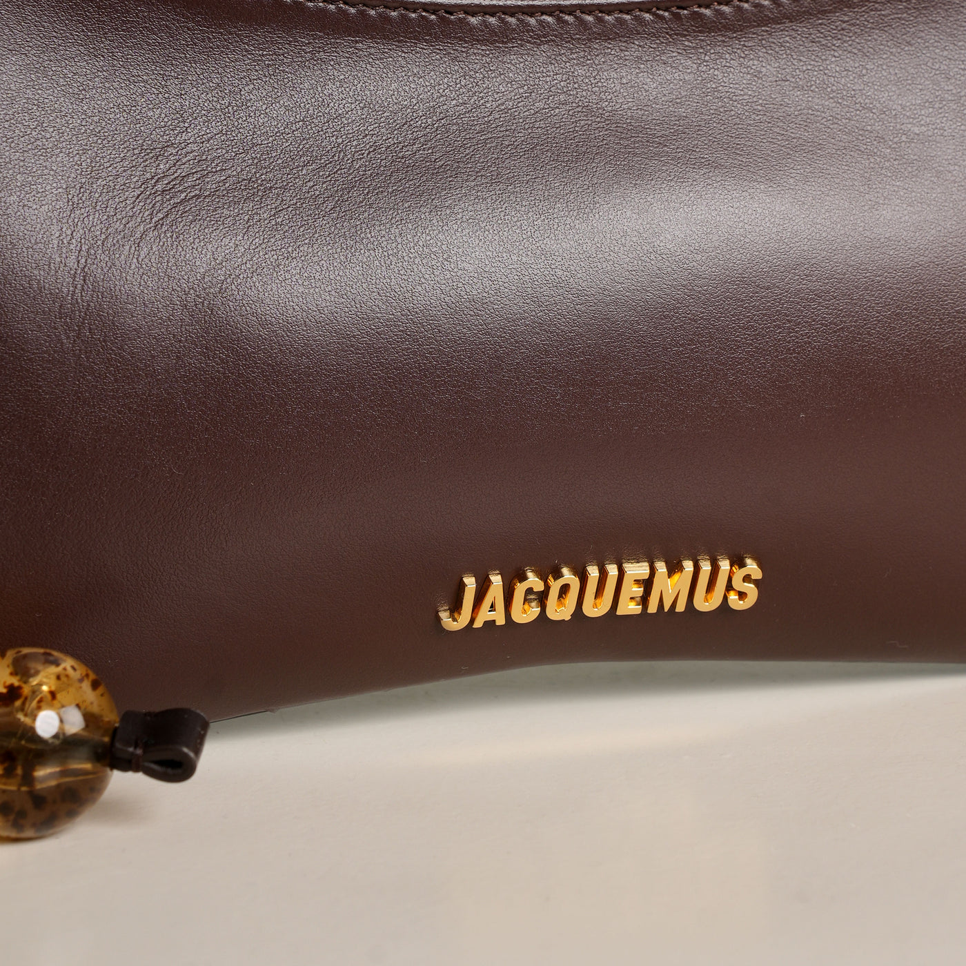 Jacquemus Le Bisou Perle gold logo hardware