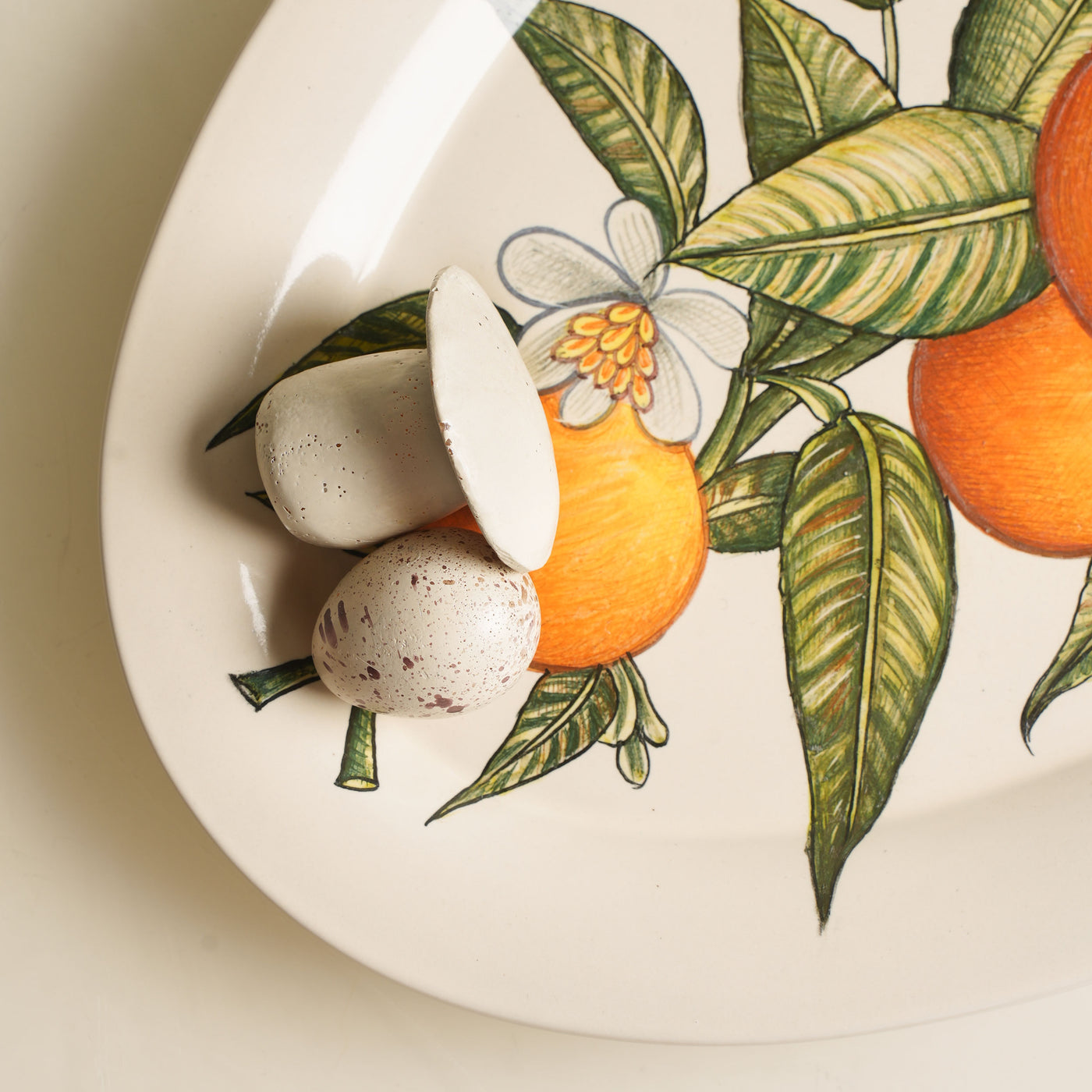 KHANOOM oval platter small orange orange print with white backdrop