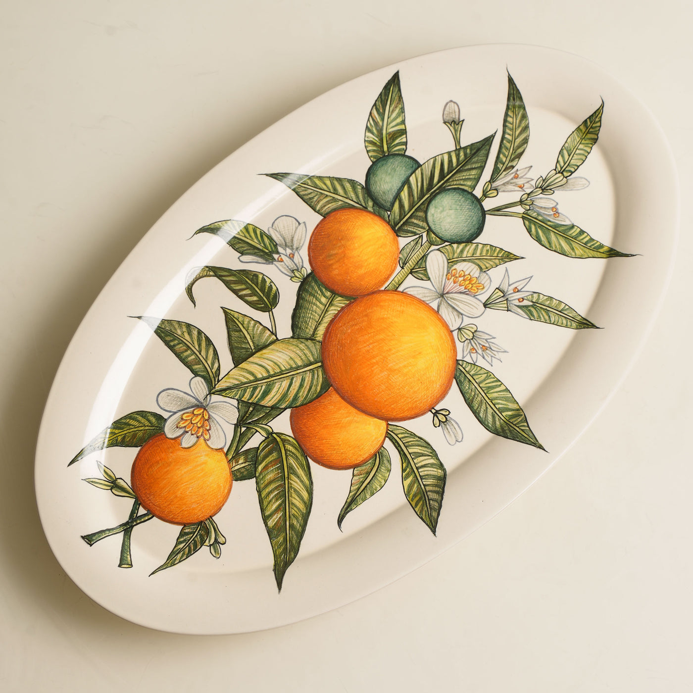 KHANOOM oval platter small orange orange print with white backdrop