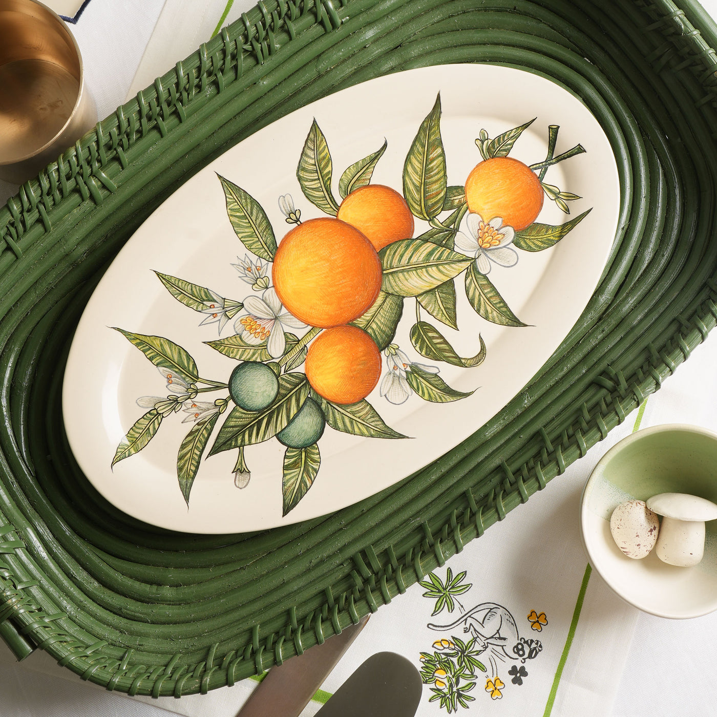 KHANOOM oval platter small orange orange print with white backdrop