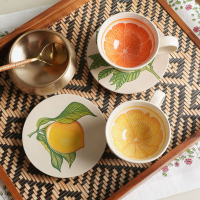 KHANOOM tea cup and saucer orange  striking orange motif with white backdrop