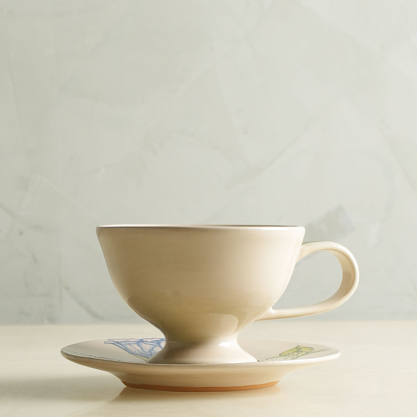 KHANOOM tea cup and saucer blue hibiscus hibiscus motif with white backdrop