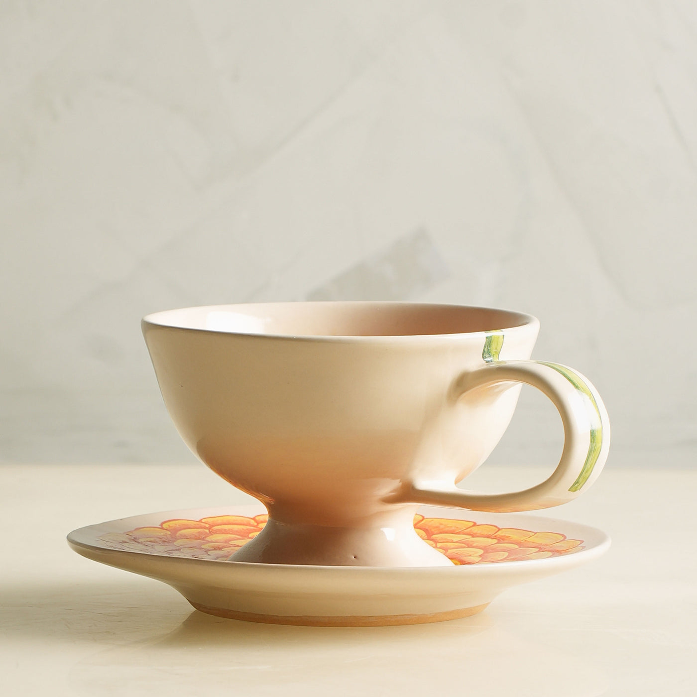 KHANOOM tea cup and saucer marigold vibrant marigold motif with timeless white backdrop