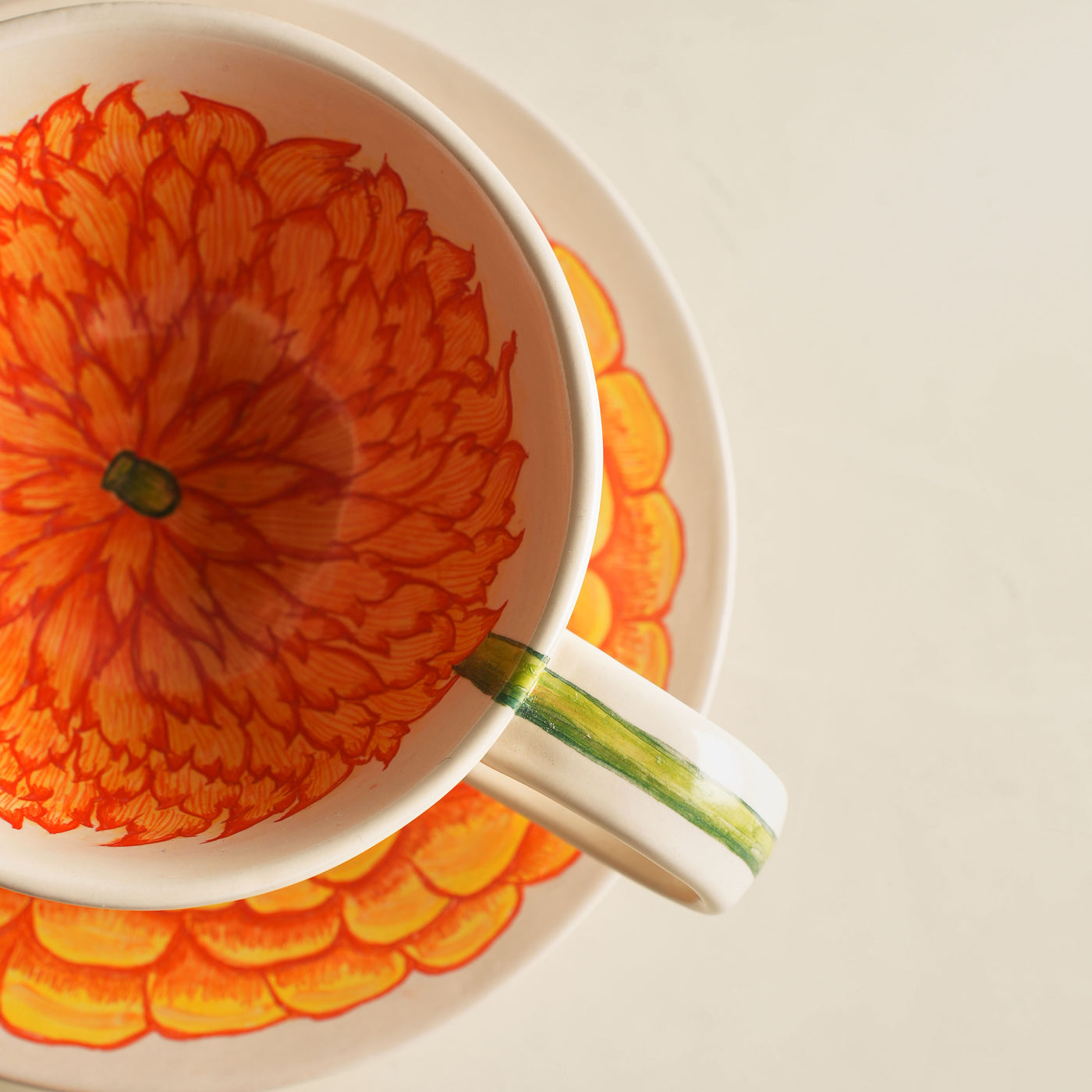 KHANOOM tea cup and saucer marigold vibrant marigold motif with timeless white backdrop