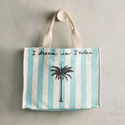 Striped tote bag with palm tree design and 'I dream in India' text 