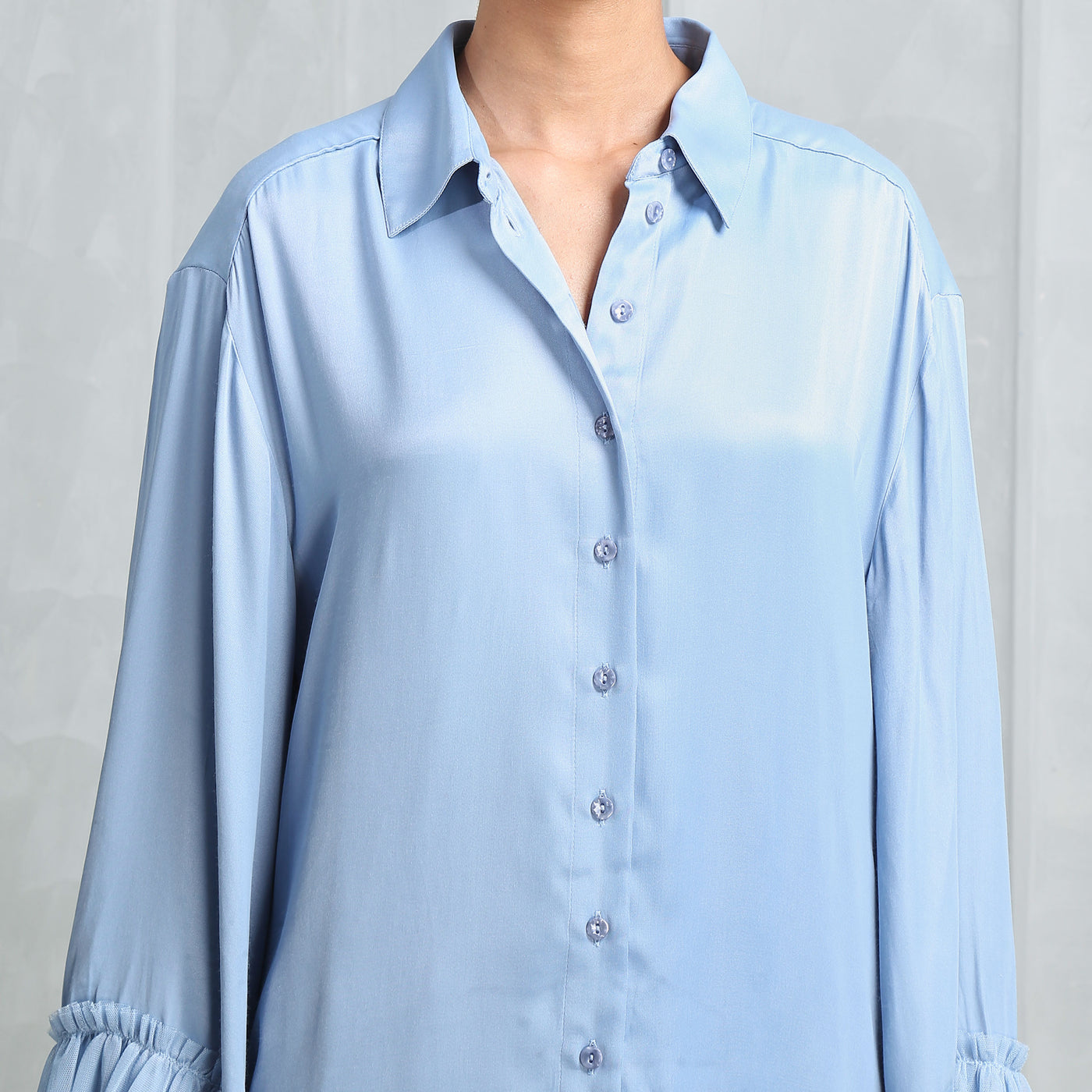 Malie Santos Ruffle-trimmed Shirt  features an oversized trim, collared neck, front button fastening.