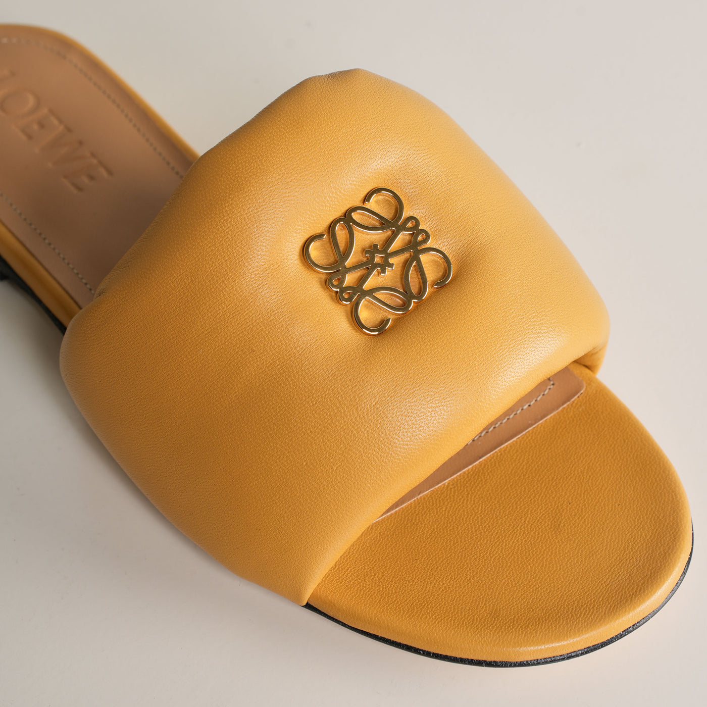 Loewe Anagram Padded Slides  feature Loewe's signature gold metal anagram. 