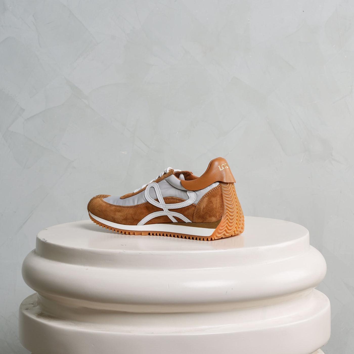 Loewe Flow Runner Sneakers a gold-stamped logo, and a honey rubber wave sole.